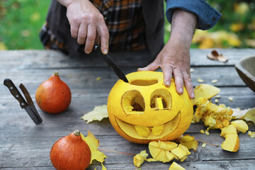 Autumn traditions and preparations for the holiday Halloween. A house in nature, a lamp made of...