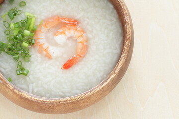 Chinese food, shrimp and rice porridge in wooden bowl 
