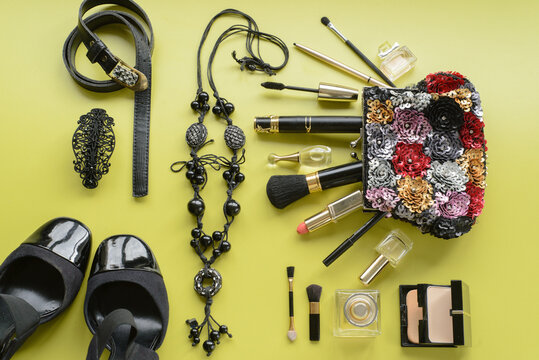 Make Up Bag With Cosmetics And Brushes, Smart-phone, Selfie Stick On Green Background. Top View. Copy Space.