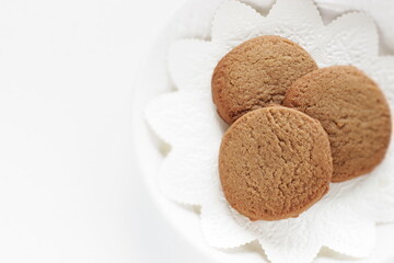 Homemade coffee cookies on lace paper with copy space