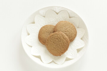 Homemade coffee cookies on lace paper with copy space