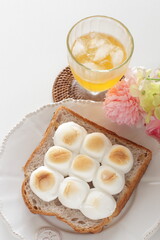 Marshmallow an walnut toast for on plate and iced drink