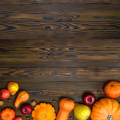 Thanksgiving day pumpkin harvest on a wooden background with empty copy space. Squash, orange...