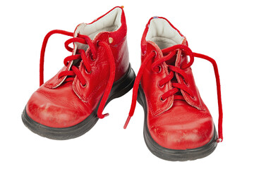 Worn out kiddie-size red lace-ups. Children's shoes with laces. Old ankle boots for small kid.