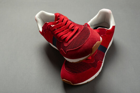 Pair Of Red Sport Shoes On Grey Background.