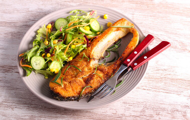Fried perch fish with salad