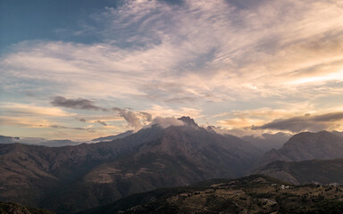 Dusk falling on the 2389 metre peak of Monte Padro and surrounding mountains in the Balagne region of Corsica
