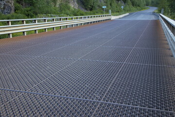 Road bridge with steel grid over Burrage River on British Columbia Highway 37A in British...