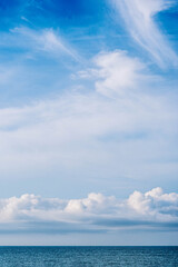 Atmosphere VERTICAL panorama real photo beauty nature wallpaper. Fantastic sky view clouds cumulus cirrus stratus sea horizon line. Wallpaper design background like painted fairy tale mood