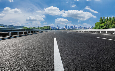 Empty asphalt road and city skyline with modern buildings scenery in Hangzhou, China.