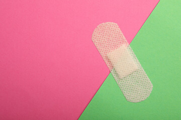 Sticking plaster on color background, top view. Space for text