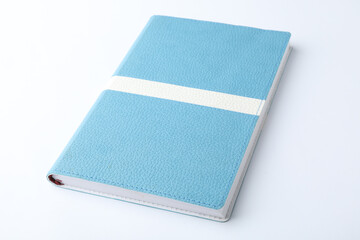 Stylish light blue notebook isolated on white