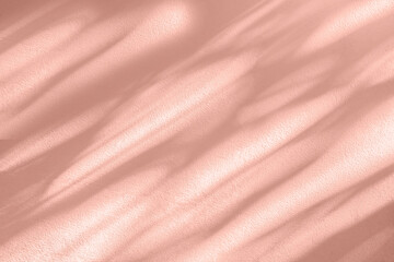 shadow and light bokeh pink coral pastel background of leaf shadow tree branch on white wall texture, nature leaves pink rose gold shadow overlay effect, mock up and design