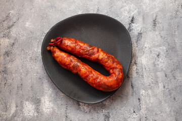 typical portuguese smoked sausage on the plate on background