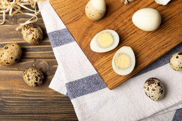 Fototapeta na wymiar Quail eggs on brown texture table background. Whole and broken quail eggs. natural products. Place for text. Fresh quail eggs.