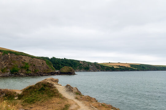 Rocky Coastline Near Par Beach And Polkerris Beach During Cloudy Rainy Day, Gribbin Head, Cornwall, UK. Footpath Along Coast