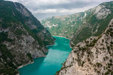 Fototapeta na wymiar Piva Lake - Amazing Mountain View in Montenegro / Alps Landscape - turquoise blue water on Balkan