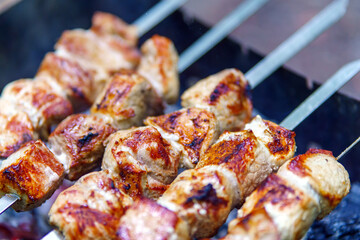 Pieces of beef meat on metal skewers kebab is fried on coals