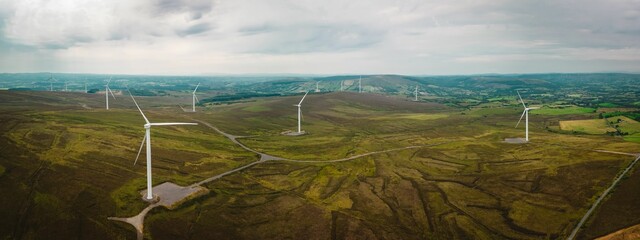 Panorama of rural landscape with a farm of wind turbines, Ireland