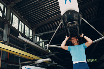 Sportsman single scull man rower prepare to competition with boat.