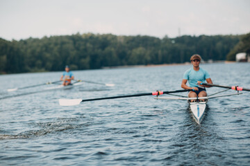 Sportsman single scull man rower rowing on boat. © primipil