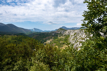 Amazing, mountain landscape of Croatian rocky hills covered in forest and vegetation with Cetina river passing through the canyon in the valley