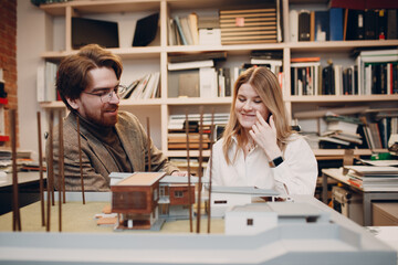 Architect with blueprints and layout design project at office bureau