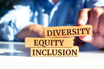 Wooden blocks with words 'Diversity Equity Inclusion'. Business concept