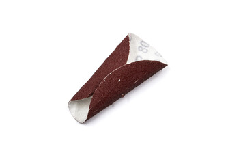Bended red sandpaper, with a granulation mark.