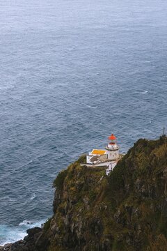 View down to lighthouse on Ponta do Arnel, Nordeste, Sao Miguel Island, Azores, Portugal.