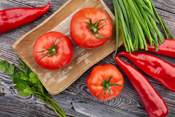 tomato on a plate on wood background