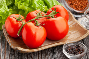 tomato on a plate on wood background
