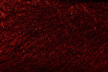 Crimson colored background with wavy textures of different shades of dark red