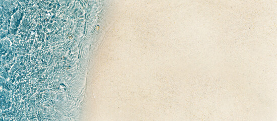 beautiful abstract sand beach from above with water and sand texture in sunshine, clean and pure...