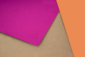 Plain and Textured pink yellow purple brown papers randomly laying to form M like pattern and triangle for creative cover design idea