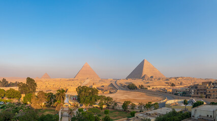 Giza, Egypt; August 16, 2022 - Sunrise at The Pyramids Of Giza, Egypt.
