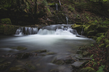 Fototapeta premium Famous Satiny waterfalls. Breathtaking, untouched nature around the water flowing down cascades creating mini waterfalls. Beskydy mountains, Czech republic, Central europe. Without human intervention