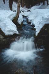 Breathtaking morning at the river Recice in Masarykovo udoli in Beskydy mountains in eastern Czech republic. Waterfall breaks through the snow. Frosty and cold morning
