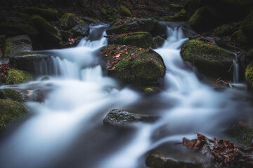 Fototapeta premium Frosty waterfall Tosanovsky in autumn colours in a beautiful unforgiving part of the Beskydy Mountains in eastern Czech republic, central Europe
