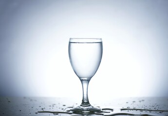 Photo of pouring water into a glass of water