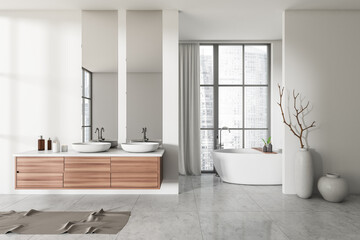 Naklejka na ściany i meble Light bathroom interior with sink and bathtub, accessories and panoramic window