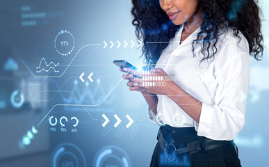 African businesswoman typing on phone, big data graph chart with
