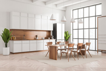 Light kitchen interior with eating table and seats, panoramic window
