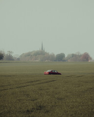 Agricultural landscape, abandoned car on field, beautiful agricultural landscape in southern sweden