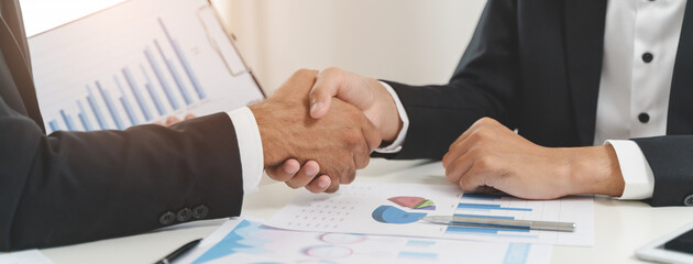 finance planning advisor and client investor shake hands agree signing contract deal after...