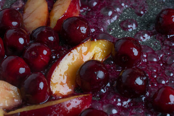 Close-up of delicious, caramelized cherries and nectarines in pan. Appetizing pan-fried fruits for dessert. Excellent image for homemade dessert banners and advertisements.
