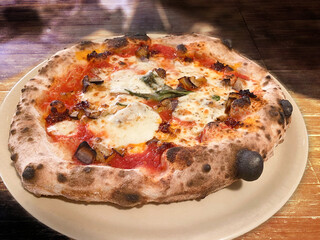 Italian Pizza three taste, with fresh mozzarella, tomato, aubergine; chili pepper, raw basil;