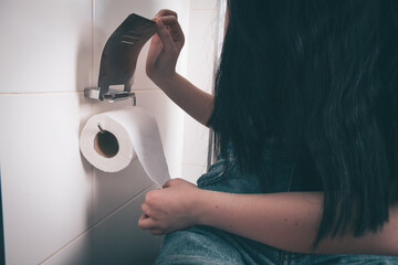 girl holding toilet papers in her hands.