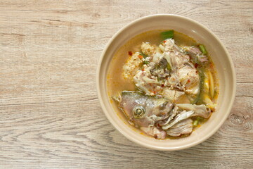 boiled Cyprinidae spicy Cyprinidae fish head and meat in Tom Yum soup on bowl