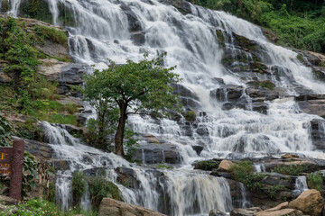 The waterfall was flowing down from the rocky cliff. At Mae Ya Waterfall, Chom Thong District, Chiang Mai Province, Thailand